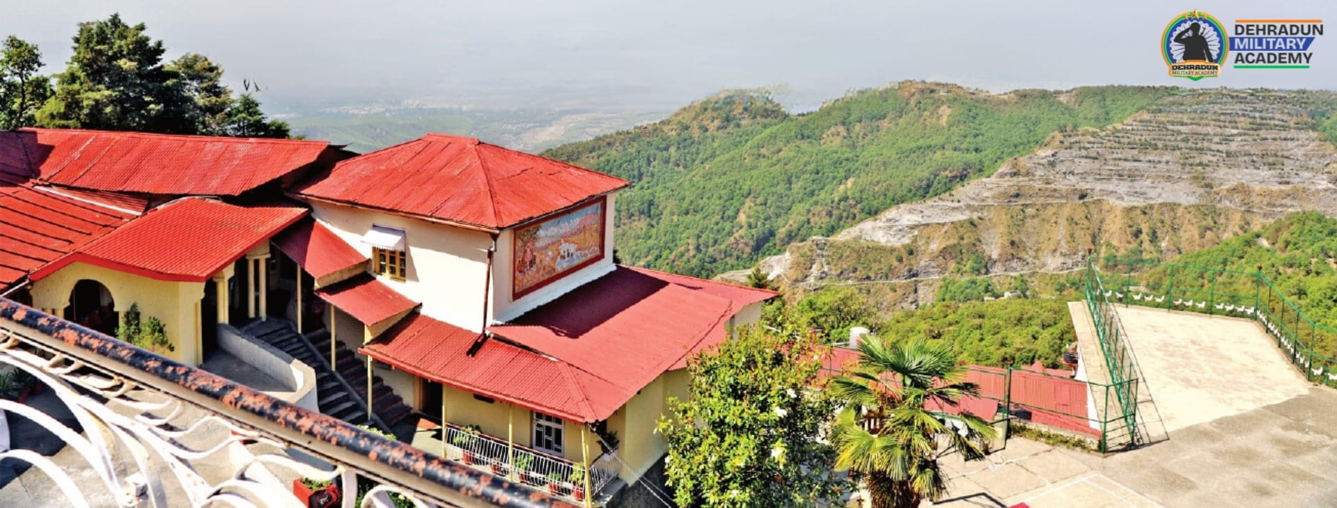 Dehradun Military Academy with mountain views, offering NDA coaching.